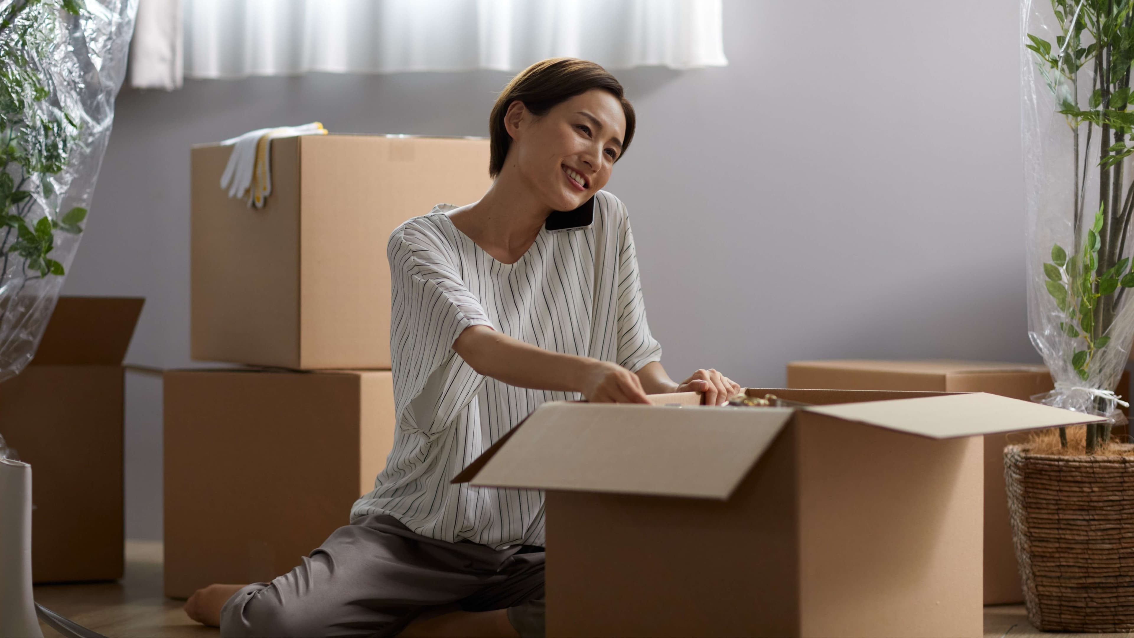 Woman packing household items during home shifting, illustrating RentOMate's flexible living solutions.